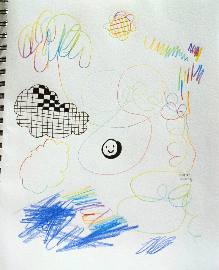 A minimalistic doodle page in pen and rainbow pencil. There are a few scribbles, a cloud covered in partially-filled-in checkerboard, and a small smiley face in the middle.